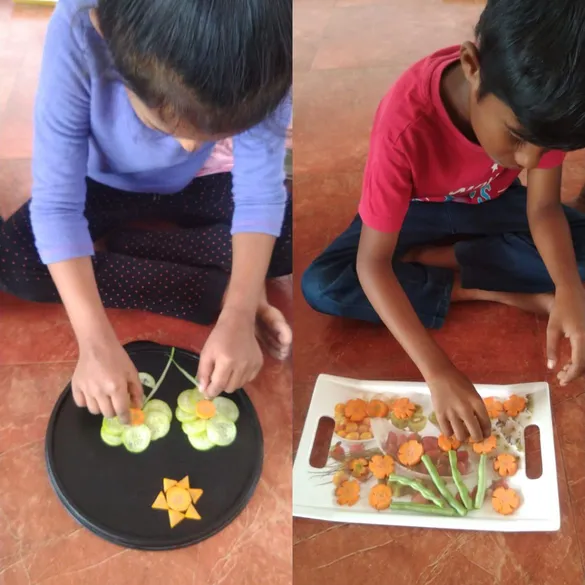 Grade 1 Nature's Palette 1_result Engrossed young students of Vidhya Peetham i-School carefully carving fruits and vegetables, demonstrating enhanced concentration and hand-eye coordination.