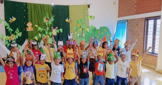 Excited first graders at Vidhya Peetham i-School celebrating after a successful performance in the White Elephant Theatre, embodying the spirit of the best CBSE school in Salem.