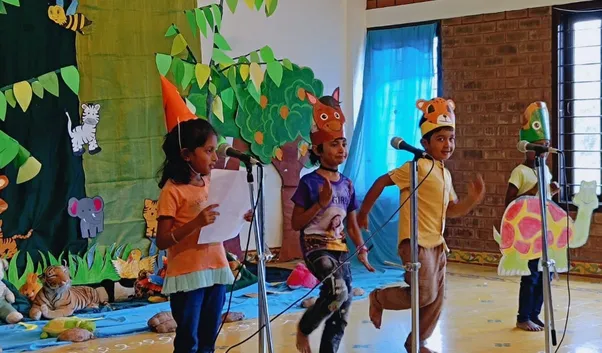 1st graders performing 'The Forest Race' skit, part of the White Elephant Theatre Activity, at Vidhya Peetham i-School, enhancing English and acting skills.