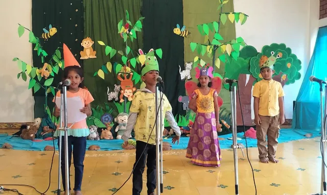 Grade 1 Theatre Activity 3_result Vibrant, green forest-themed backdrop with waterfall used for White Elephant Theatre skits at Vidhya Peetham i-School, Salem's top CBSE school.
