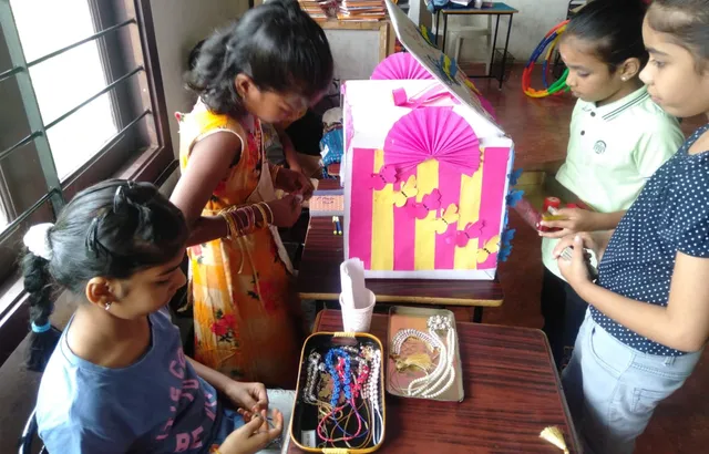Vibrant classroom at Vidhya Peetham i-School transformed into a fancy store, with students learning multiplication through hands-on experience in selling and buying.
