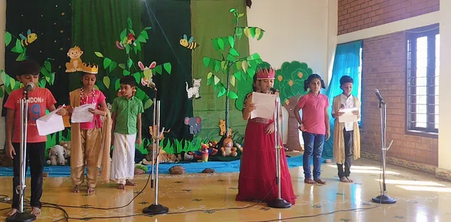 3rd graders from Vidhya Peetham i-School performing 'The Monkey and the King' skit, demonstrating their talent and confidence on stage.