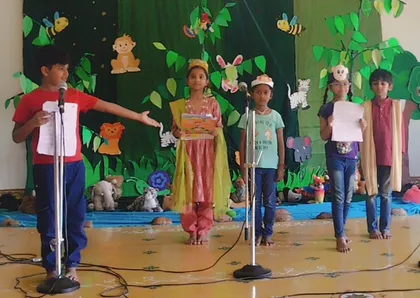 Vidhya Peetham i-School 3rd graders practicing their skits for children in the classroom with microphones, showcasing their developing public speaking skills.