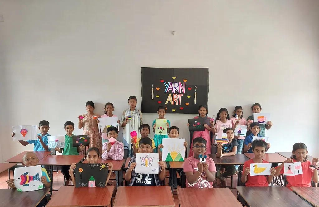 Smiling fifth-grade students at Vidhya Peetham i-School holding up their completed yarn art crafts, including a vivid butterfly and a cheerful panda, demonstrating the creativity fostered at this CBSE school in Salem.