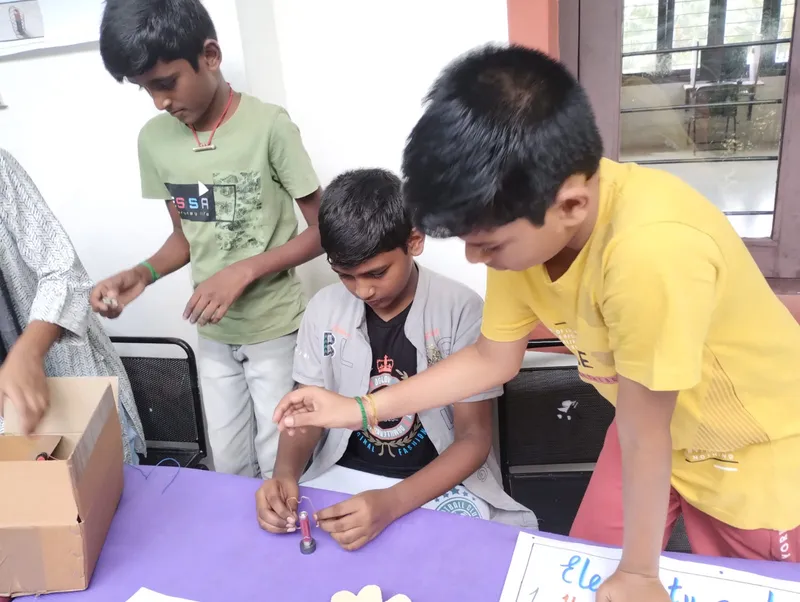 Collaborative learning in action as Grade 6 students work together to construct electrical circuits at a leading Salem CBSE school.
