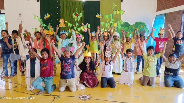 Second graders practicing with microphones and background music for their Jataka Tales performance, exemplifying the focus on holistic development at the best school in Salem.