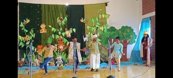Joyful second-grade students performing a rain dance in the 'Wise Parrot' drama, capturing the essence of teamwork and creativity at Vidhya Peetham i-School, a renowned CBSE school in Salem.