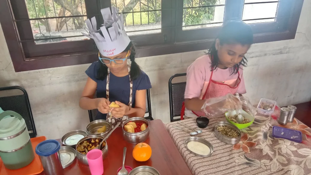 A vibrant classroom scene of Grade 3 children at one of the best schools in Salem, enjoying their self-made healthy dishes during a flameless cooking session.