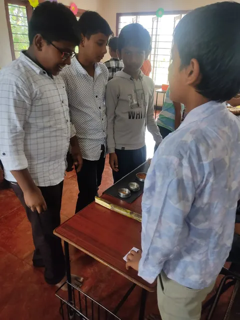 Grade 4 students displaying metallic minerals, fostering hands-on learning about India's natural resources.