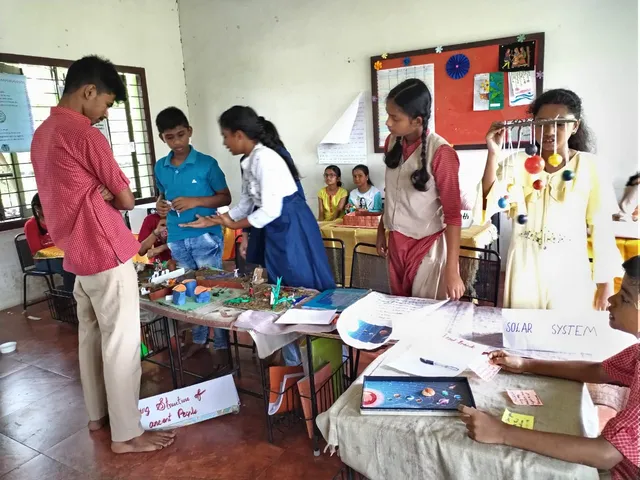 Interactive session with students demonstrating a solar system model in a science expo at a top school in Salem.