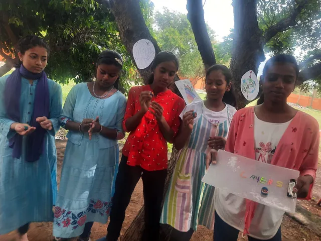 Salem schoolgirls participating in an educational earth science activity outdoors.