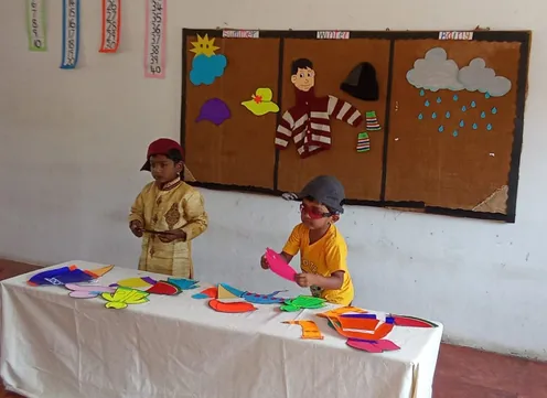LKG students at Vidhya Peetham i-School in Salem engage in a 'Kindergarten Seasons Activity,' sorting colorful cutouts of summer accessories on a table.