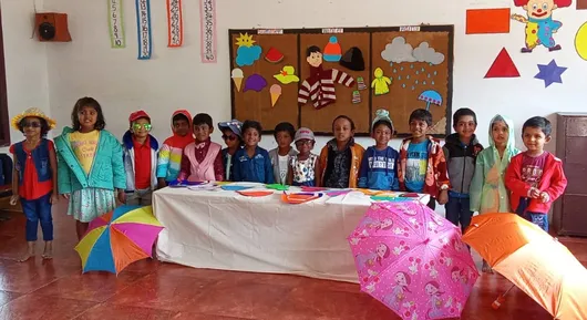 Salem's young students at Vidhya Peetham i-School show off sunglasses and umbrellas, representing summer and rainy seasons in their educational activity.