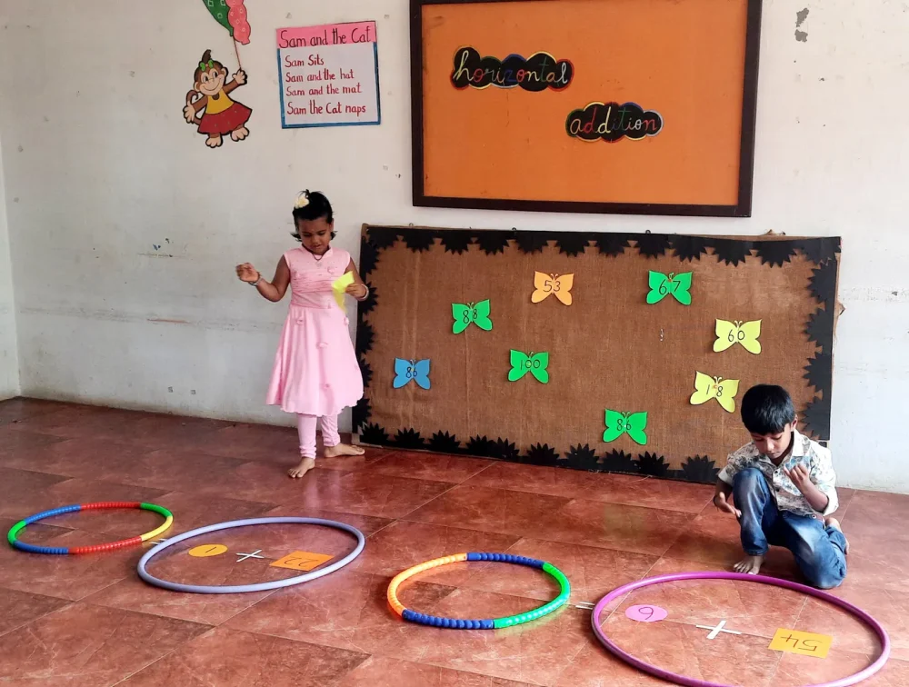 Dedicated students at a leading school in Salem engaging in horizontal addition with creative floor mats and paper butterflies, showcasing fun learning methods.
