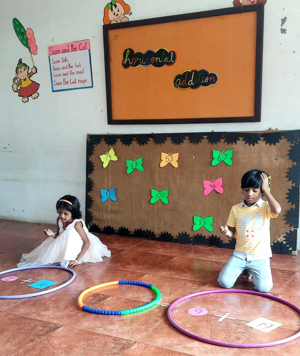 Kids at Vidhya Peetham i-School, the best CBSE school in Salem, enjoying a hands-on addition lesson with vibrant hula hoops and butterfly cut-outs.