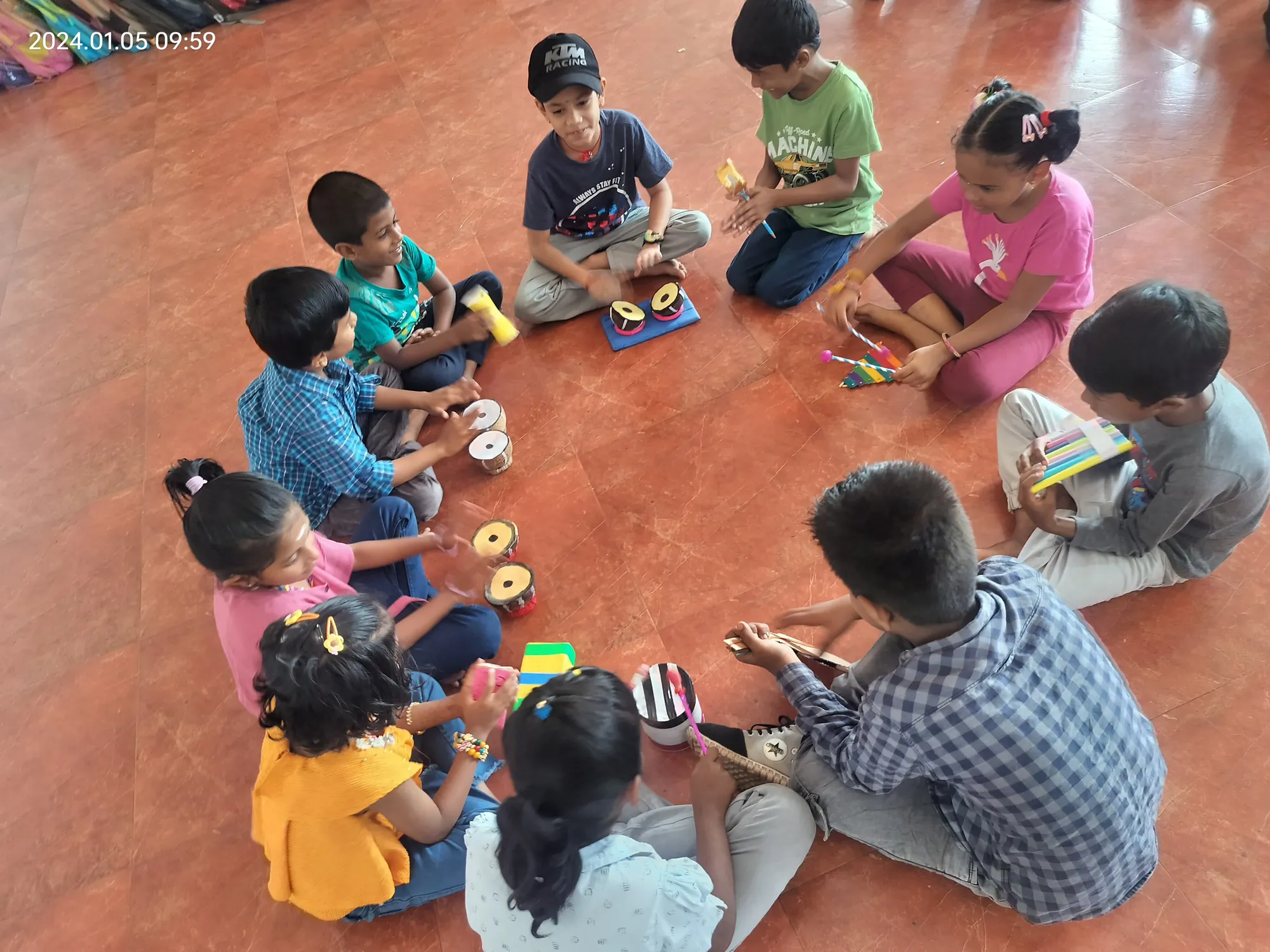 First graders collaborating on sound recognition, learning about pitch and rhythm using their DIY instruments in a fun-filled classroom at a top school in Salem. ??