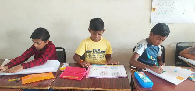 Students at one of the top schools in Salem diligently working on their school rules posters with intense concentration.