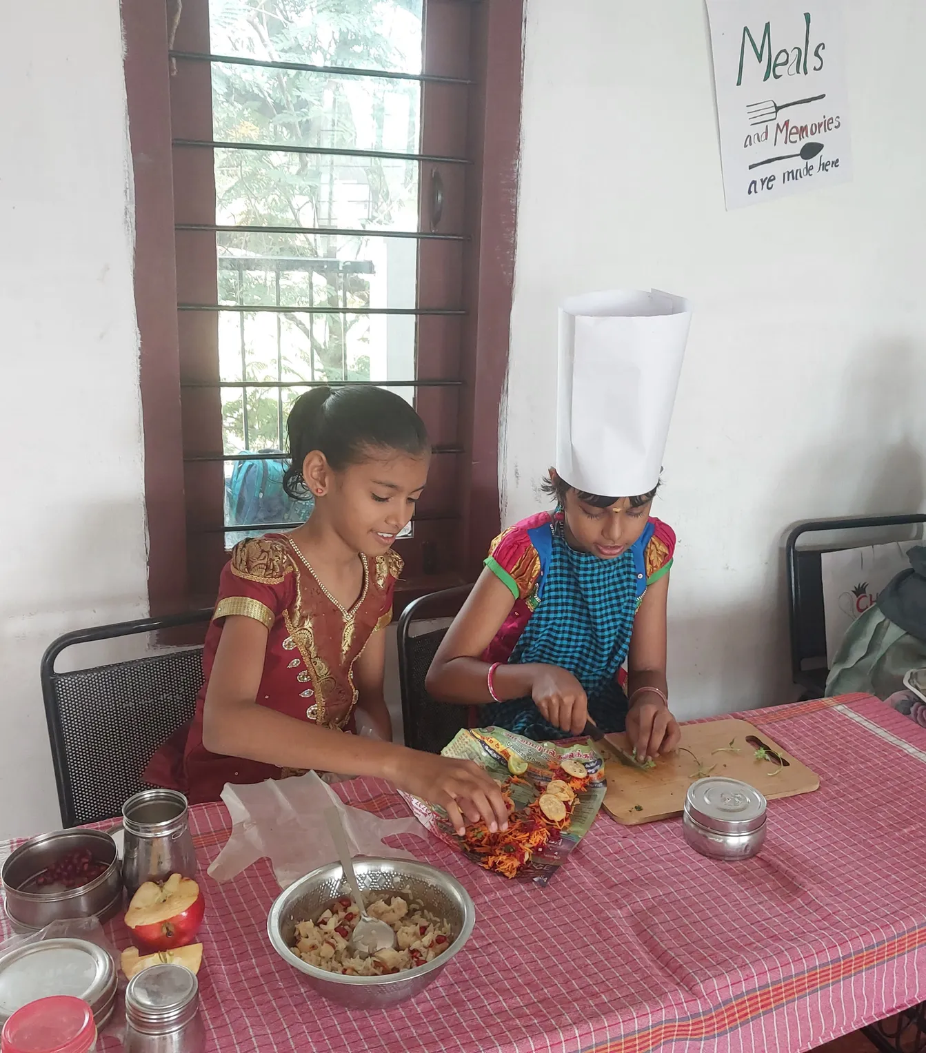 Students at Vidhya Peetham i-School engage in preparing traditional South Indian flameless dishes.