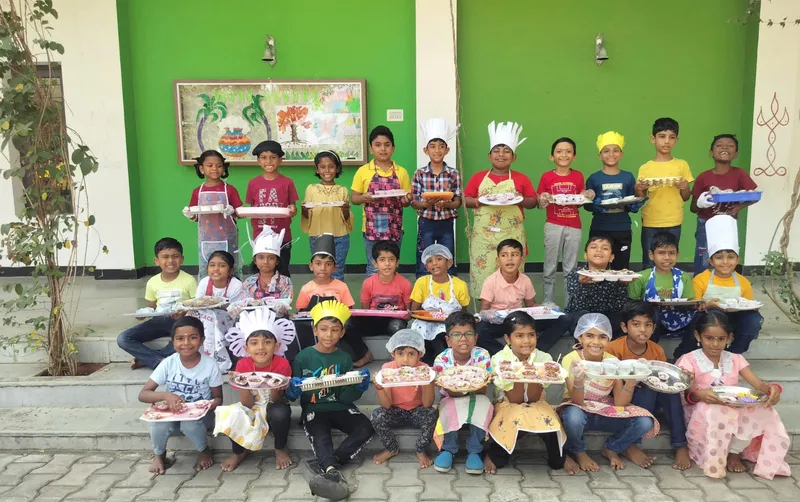 An array of Grade 2 students at one of the top schools in Salem, showcasing their freshly made Crispy Chocolate Cakes in the classroom.