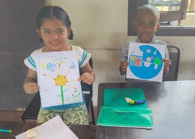 Two young students working on their cotton bud art projects at Vidhya Peetham i-School.