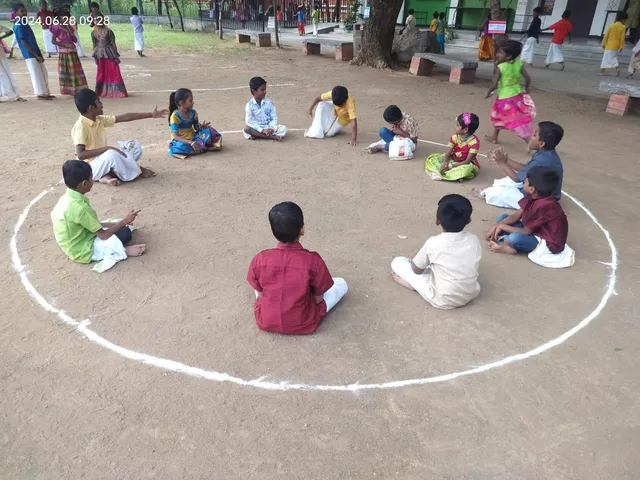Group of children laughing and playing a traditional game.