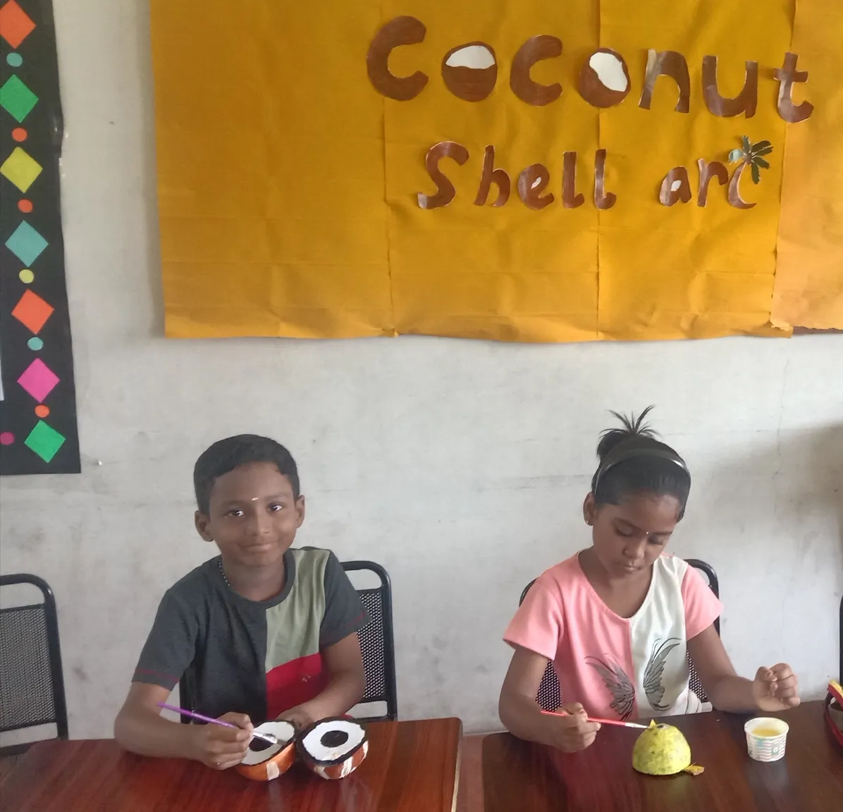 Grade 3 students proudly displaying their coconut shell art creations at a CBSE school in Salem.