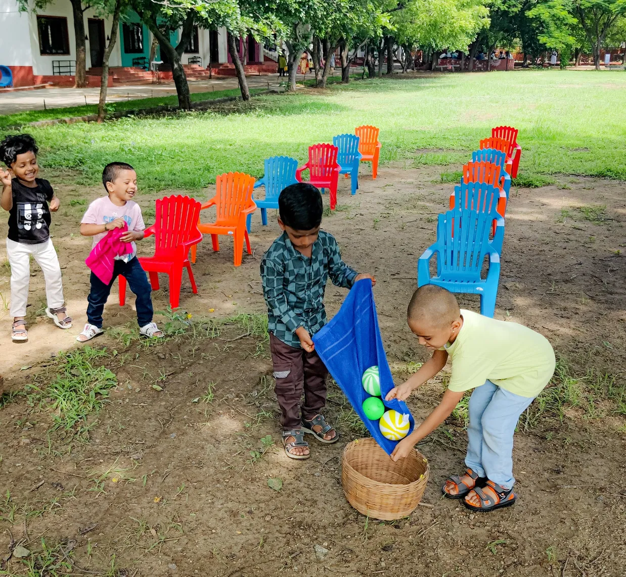 Children participating in a ball balancing activity at Vidhya Peetham i-School to develop gross motor skills.