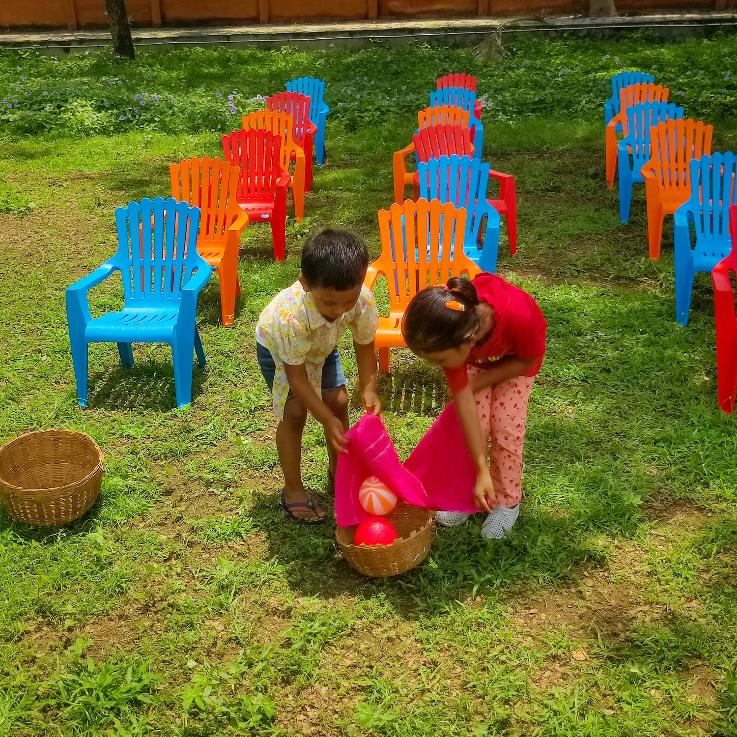 Vidhya Peetham i-School LKG students practicing coordination and concentration through a ball balancing activity in the school ground.