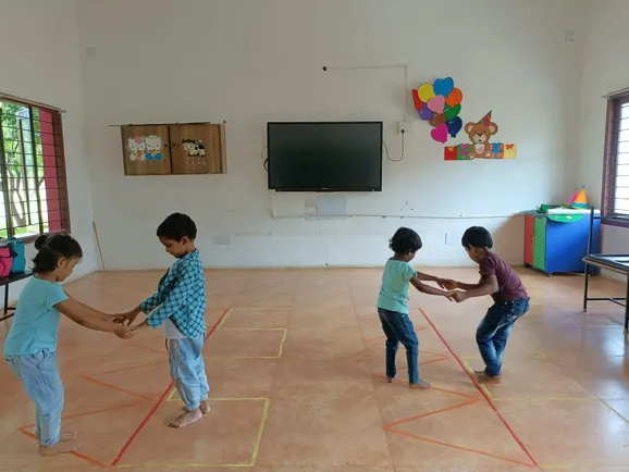 Students enjoying the Walk the Line activity, improving their motor skills.
