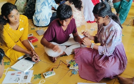 Students working on a practical electronics exercise with a multimeter at a CBSE school in Salem.