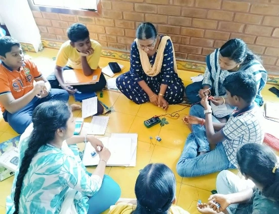 Students assembling a seven-segment display on a breadboard during the electronics workshop.