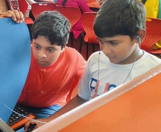 Students engaged in Scratch programming