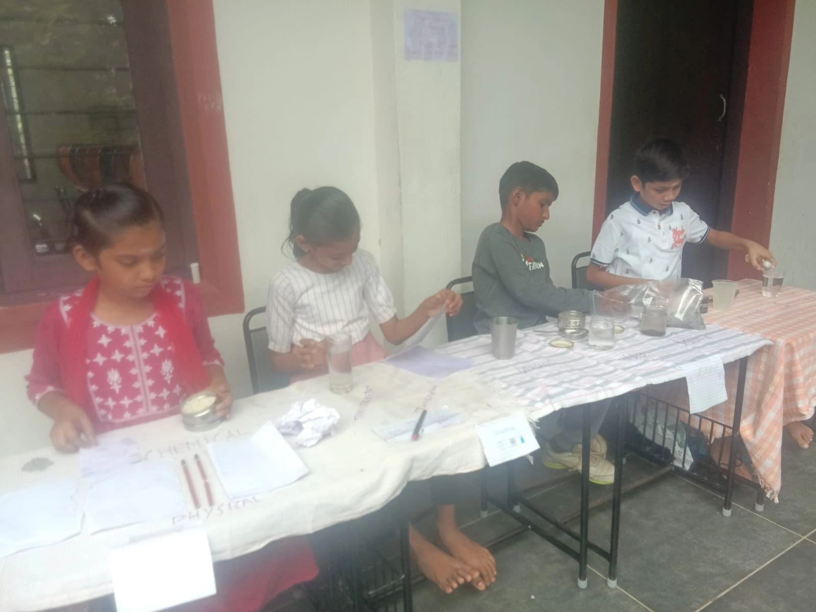 Children engaged in sorting materials into groups activity at Vidhya Peetham i-School