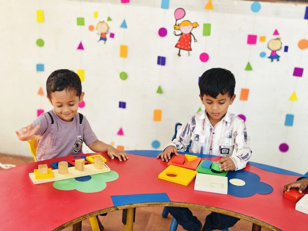 Kindergarten students developing spatial awareness through shape play