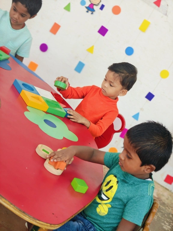 Children engaging with geometric shapes in interactive learning session