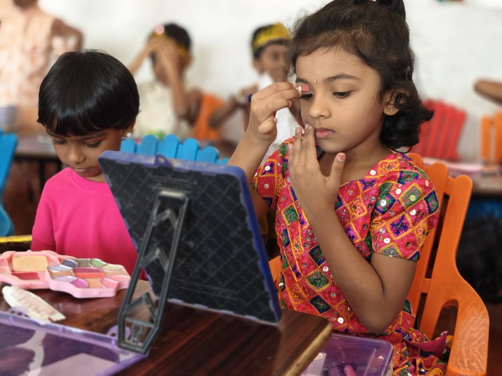 Young student applying makeup independently during cultural activity
