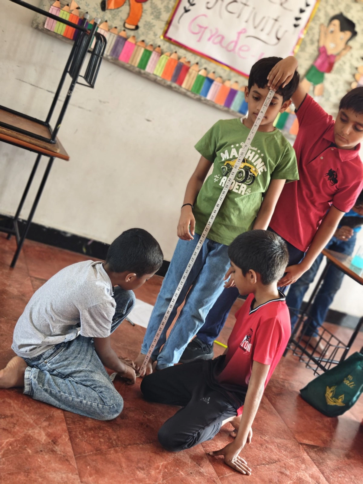 Grade 4 students measuring objects with ruler
