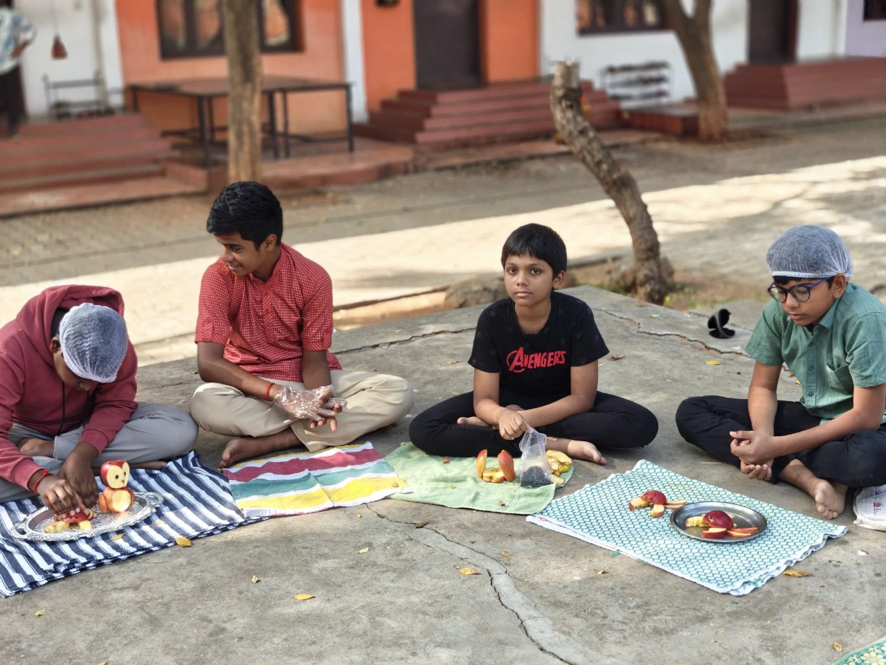 Group of students displaying their fruit carving skills in the school courtyard