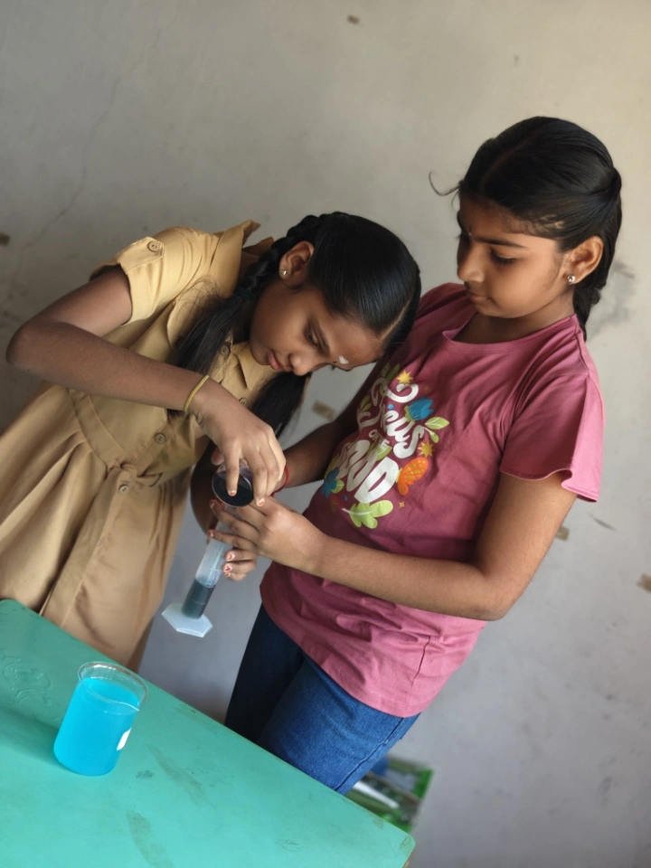 Students conducting volume measurements in science lab
