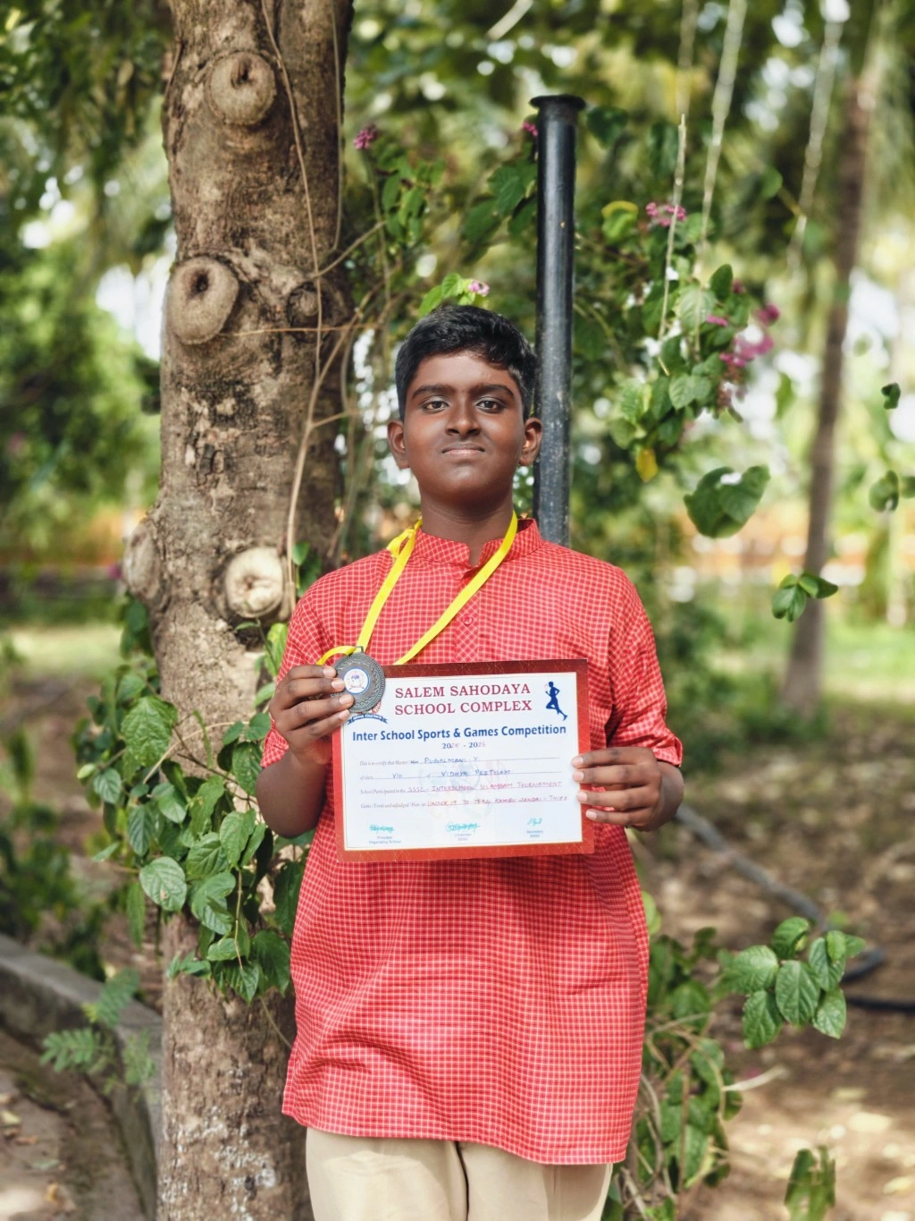 Grade 8 Silambam bronze medalist Pugalmani with certificate from Salem Sahodaya sports competition